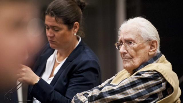 Defendant Groening sits next to his lawyer Susanne Frangenberg in the courtroom before the start of his trial in Lueneburg