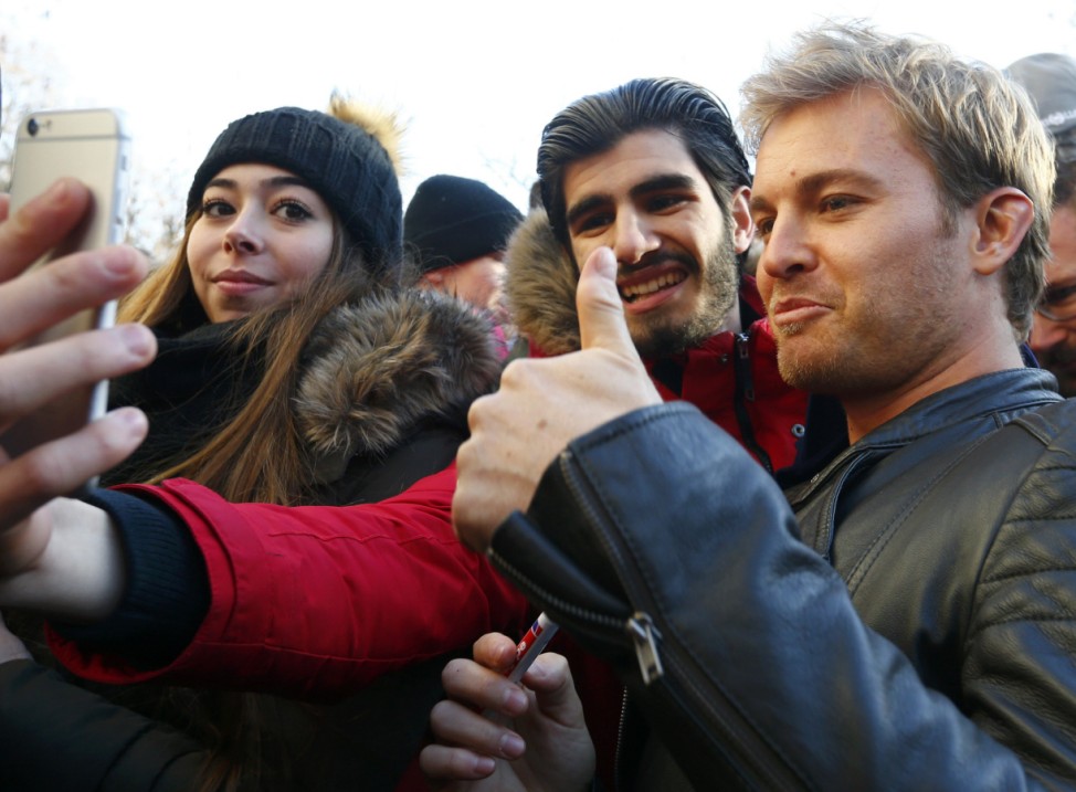 Mercedes' Formula One World Champion Rosberg takes a selfie with fans during his visit to Wiesbaden