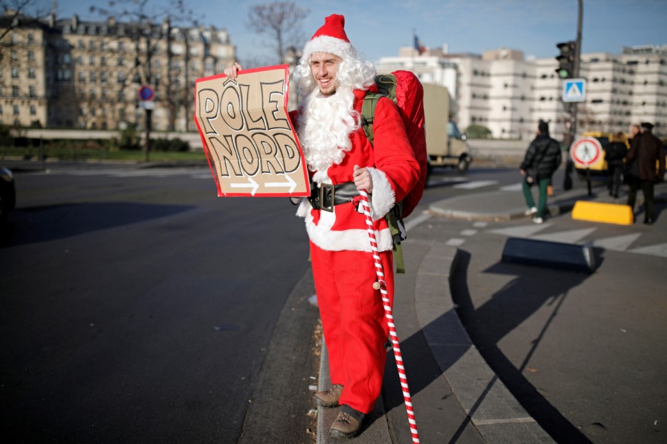 French adventurer Capitaine Remi Le Calvez dressed as a Santa Claus, starts a trip as a hitchhicker in Paris
