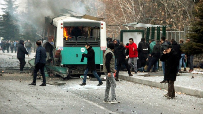 People react after a bus was hit by an explosion in Kayseri