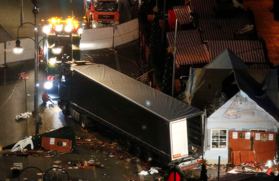 A tow truck operates at the scene where a truck that ploughed through a crowd at a Berlin Christmas market