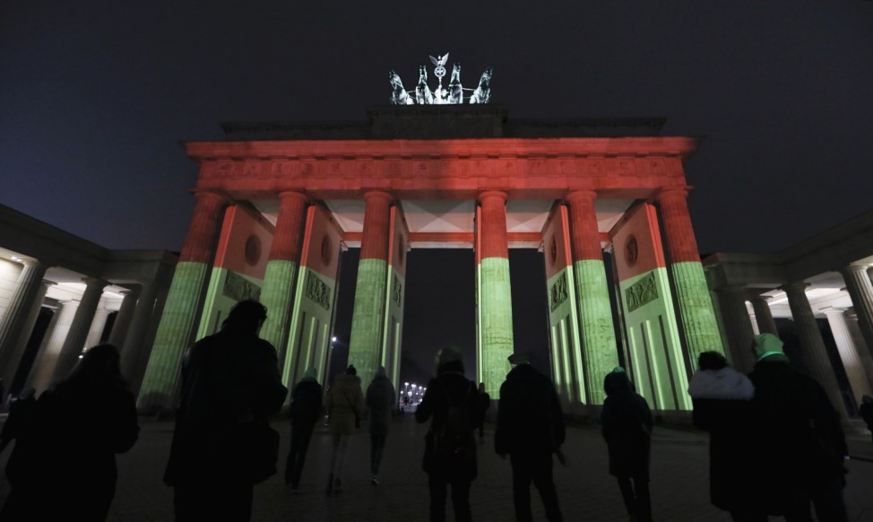 Brandenburg Gate is illuminated to commemorate the 12 killed victims of a truck that ploughed into a crowded Christmas market in Berlin