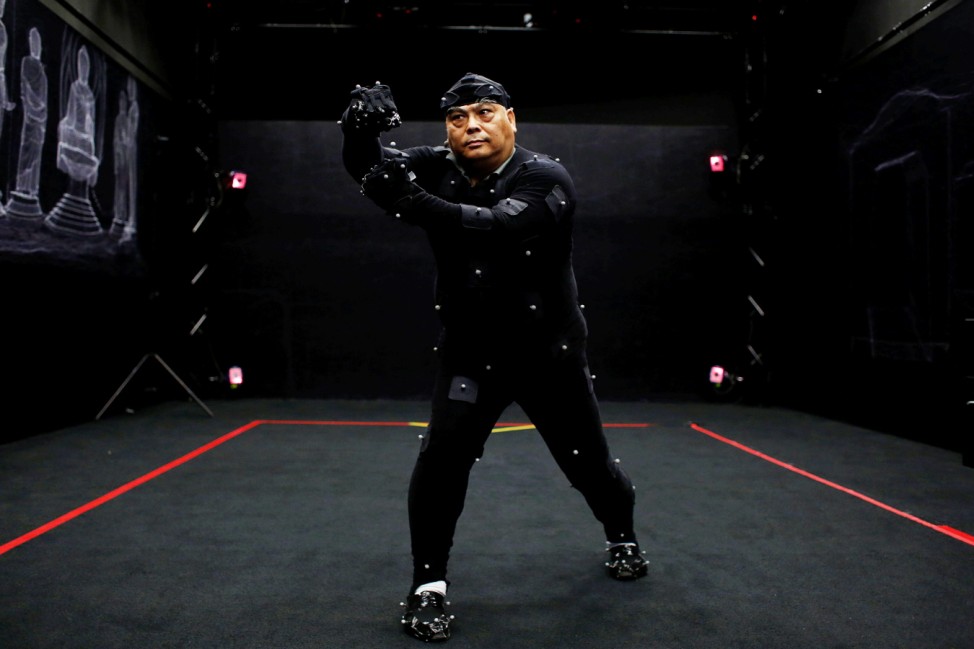 Dragon Sign kung fu master Wong Yiu-kau, in a black body-hugging motion-capture suit with markers, performs during a recording in Hong Kong