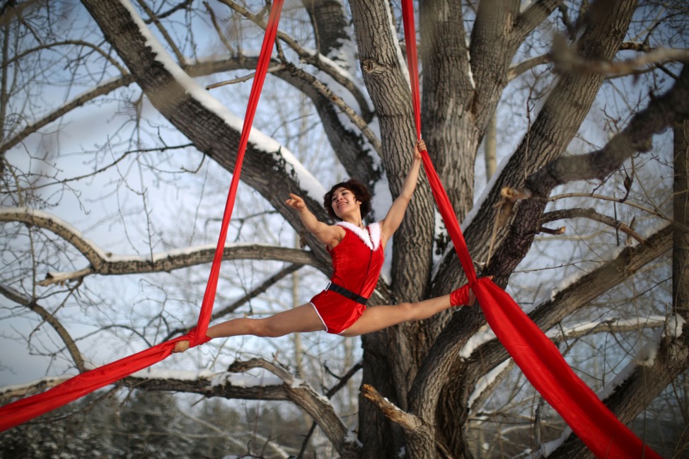 A dancer performs on a tree in temperatures below minus 37 degrees Celsius in Mohe