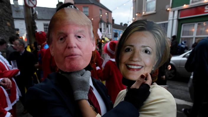 People costumed as Donald Trump and Hillary Clinton are seen during an Irish tradition of Hunting of the Wren festival held every St. Stephen's Day
