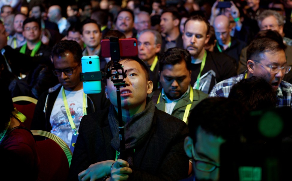 A showgoer uses two smartphones before the Nvidia keynote address at CES in Las Vegas
