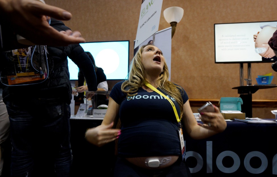McCall Peck, 8 months pregnant, shows off the Bloomlife Smart Pregnancy Tracker stuck to her belly which tracks and counts labor contractions at home at CES in Las Vegas