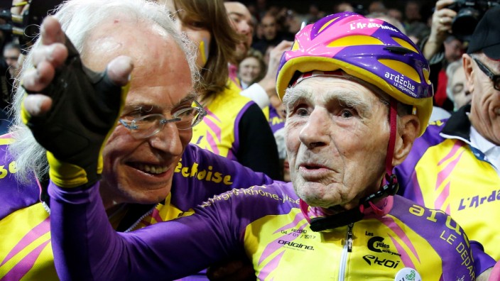 French cyclist Robert Marchand, aged 105, reacts after he rode 22.528 km (14.08 miles) in one hour to set a new record at the indoor Velodrome National in Montigny-les-Bretonneux