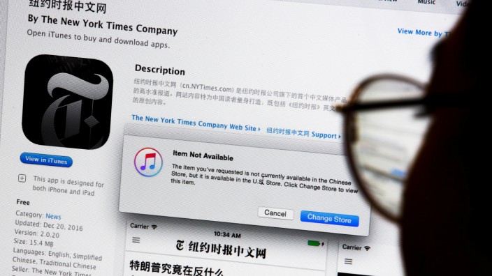 An illustration shows a person looking at a computer screen in Beijing showing an Apple iTunes store message saying that the New York Times app is not available in the Chinese store