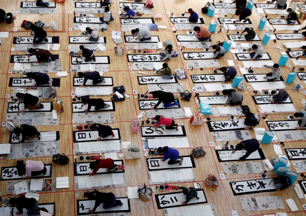 Participants write at a New Year calligraphy contest in Tokyo