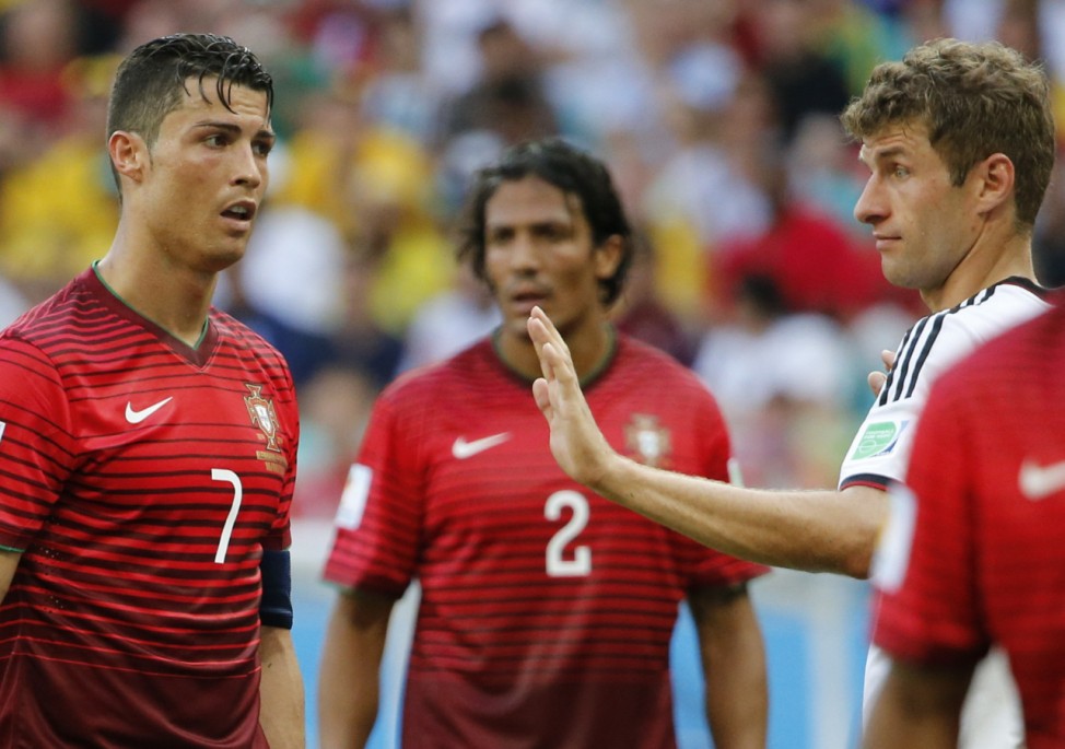 Portugal's Ronaldo and Germany's Mueller look at each other during their 2014 World Cup Group G soccer match at the Fonte Nova arena in Salvador