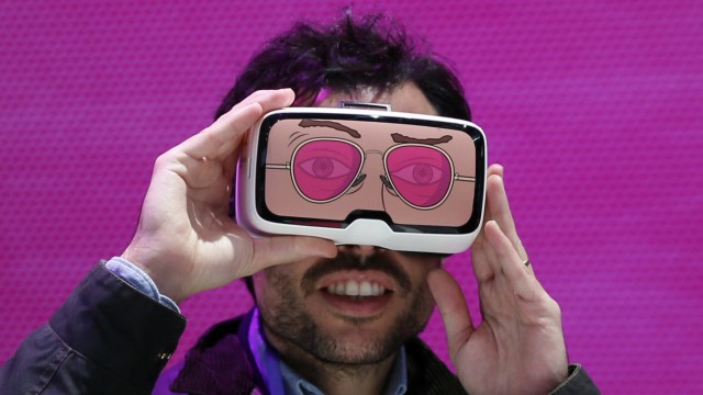 A man tests the 'Zeiss VR One' virtual reality glasses during the Mobile World Congress in Barcelona