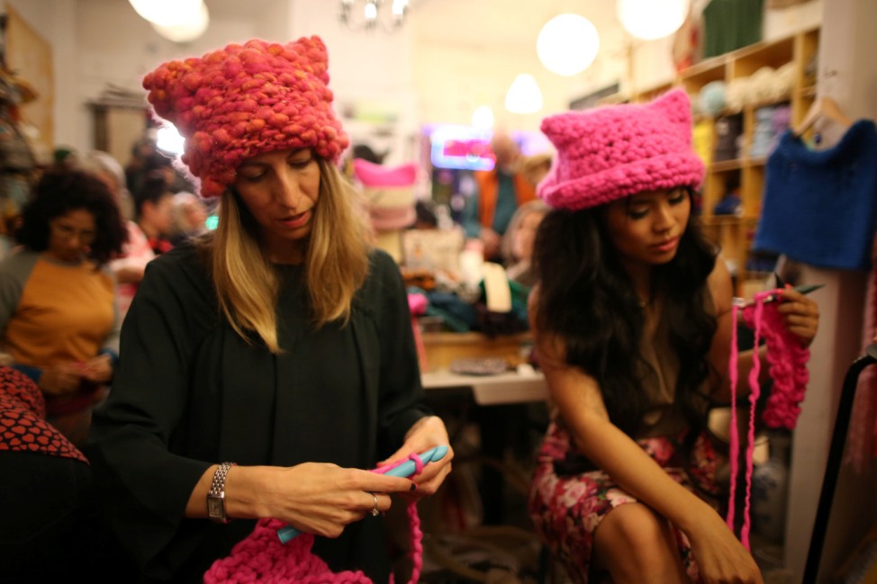 Jayna Zweiman and Krista Suh take part in the Pussyhat social media campaign they created to provide pink hats for protesters in the women's march in Washington, D.C., the day after the presidential inauguration, in Los Angeles, California