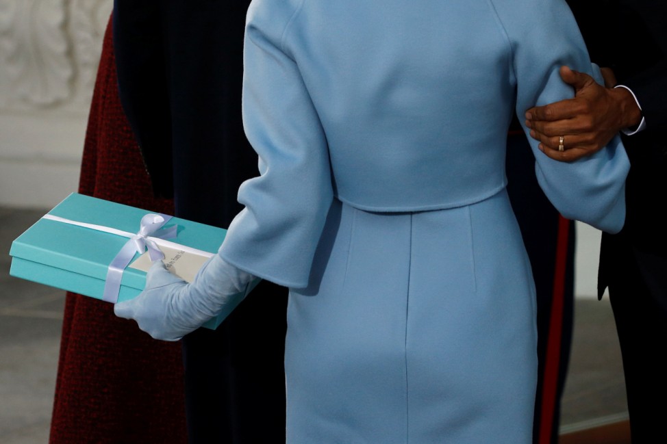 Trump's wife presents a gift to the Obamas as the Trumps arrive for tea before the inauguration at the White House in Washington