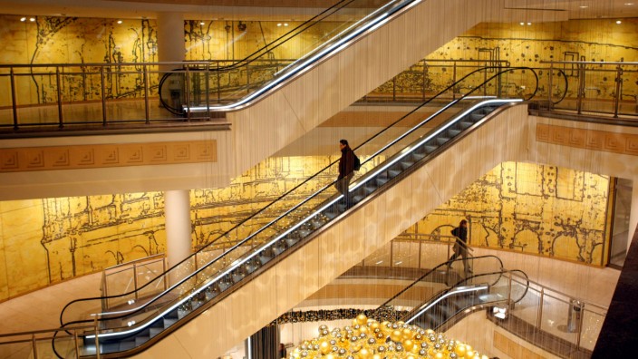 A customer uses the escalators in a shopping mall in Essen