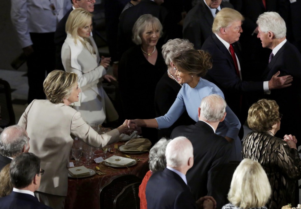 Hillary Clinton greets Melania Trump as her husband Bill Clinton speaks with Donald Trump during the Inaugural luncheon in Washington