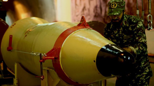 Member of the Iranian Revolutionary Guards checks a missile inside an underground depot in an undisclosed location, Iran, in this handout photo released by the official website of Islamic Revolutionary Guard Corps