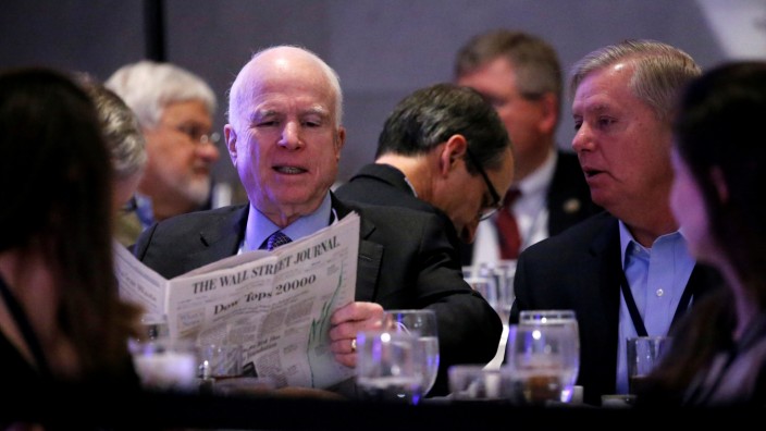 McCain and Graham chat before President Donald Trump arrives to speak at a congressional Republican retreat in Philadelphia