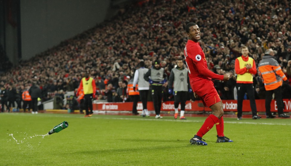 Liverpool's Georginio Wijnaldum celebrates scoring their first goal as a bottle is thrown onto the pitch