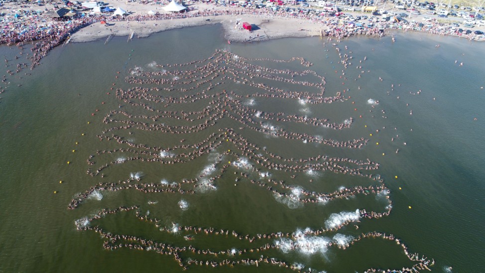 Nearly 2,000 people float in a line setting a new Guinness world record for the most people floating while holding hands in Lake Epecuen