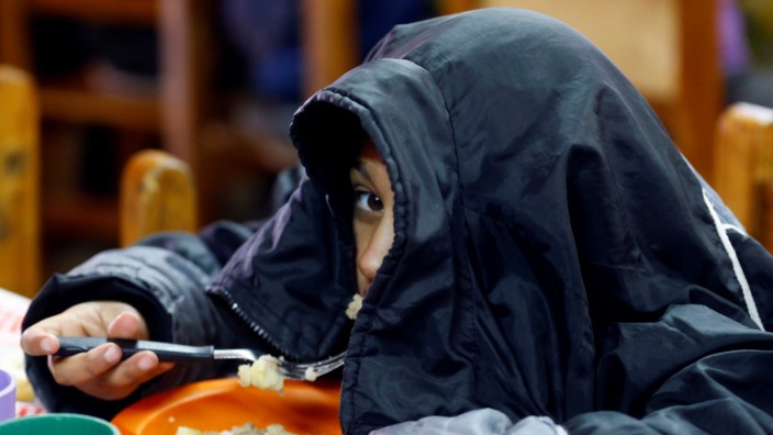 A child eats at the community youth center 'Che Pibe' in Villa Fiorito, on the outskirts of Buenos Aires, Argentina