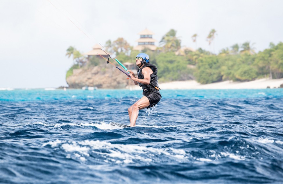 Former U.S. President Barack Obama tries his hand at kite surfing during a holiday with British businessman Richard Branson on his island Moskito, in the British Virgin Islands, in a picture handed out by Virgin