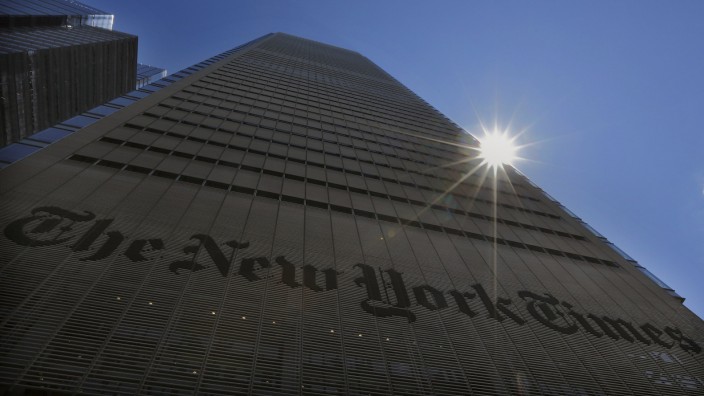 File photo of the sun peaking over the New York Times Building in New York