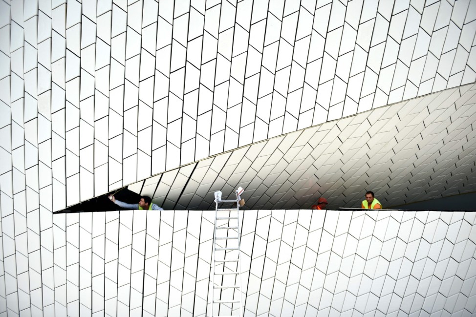 Construction workers finish the last details of the new MAAT (Museum of Art, Architecture and Technology) in Lisbon