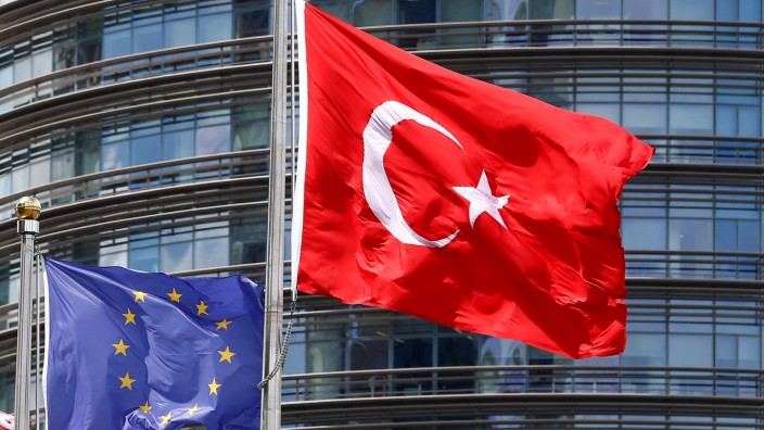 A European Union and Turkish flag fly outside a hotel in Istanbul
