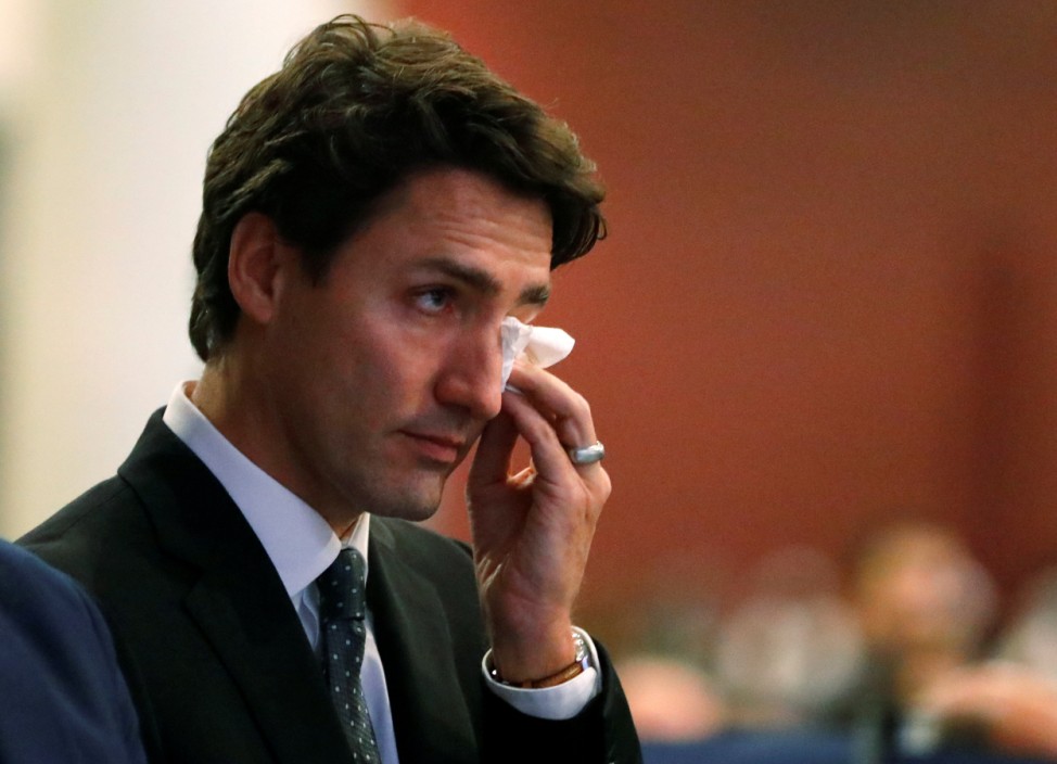 Canada's Prime Minister Justin Trudeau wipes a tear during funeral services for three of the victims of the deadly shooting at the Quebec Islamic Cultural Centre, at the Congress Centre in Quebec City