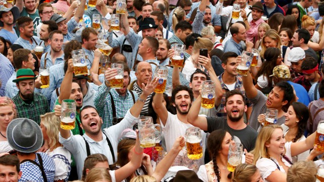 Visitors cheer with beer during the opening day of the 183rd Oktoberfest in Munich
