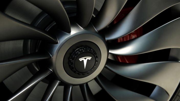 A wheel of a  prototype of the Tesla Model 3 on display in front of the factory in Sparks