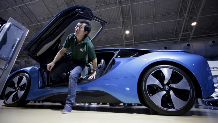 FILE PHOTO:A visitor gets out of a new BMW i8 plug-in hybrid sports car during the Auto China 2016 in Beijing