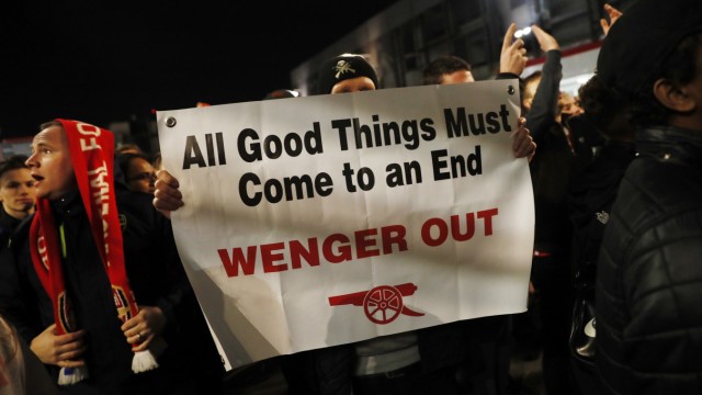 Fans protest against Arsenal manager Arsene Wenger outside the stadium before the match
