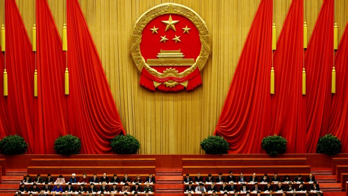 FILE PHOTO:  China's President Xi Jinping and other delegates listen as China's Premier Li Keqiang (not pictured) delivers a government work report during the opening session of the National People's Congress at the Great Hall of the People in Beijing