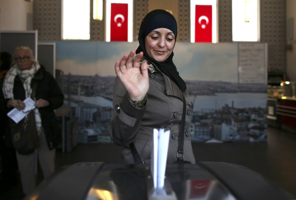 A woman votes in the general elections in a mosque in the Amsterdam