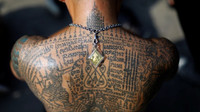 A devotee attends the religious tattoo festival at Wat Bang Phra where they come to recharge the power of their sacred tattoos in Nakhon Pathom province