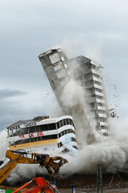 The Bonn Center topples during a controlled demolition in Bonn