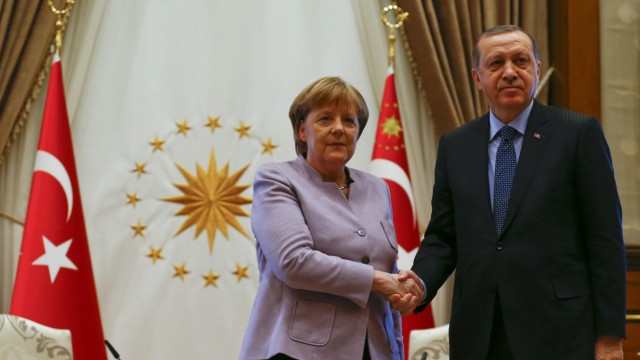 Turkish President Erdogan and German Chancellor Merkel exchange a handshake in Ankara