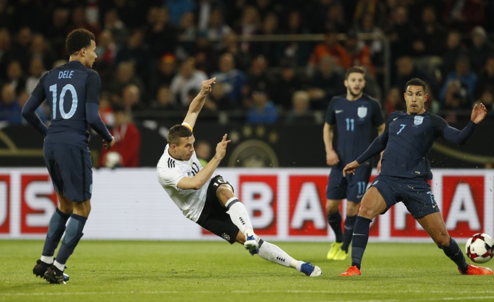 Germany's Lukas Podolski in action with England's Jake Livermore