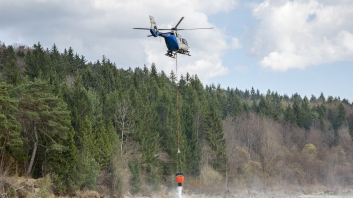 Pupplinger Au: Vier Helikopter waren am Mittwoch in der Luft, um den Waldbrand in der Pupplinger Au zu löschen. Immer wieder schöpften sie Wasser aus der Isar.