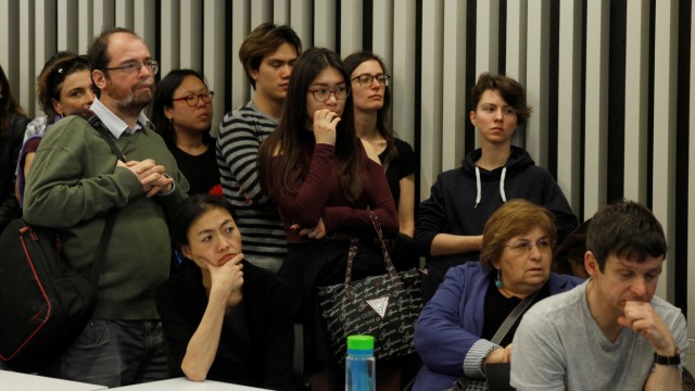 Students of the Hungary-based Central European University listen to the school's rector, Michael Ignatieff, address a town hall meeting
