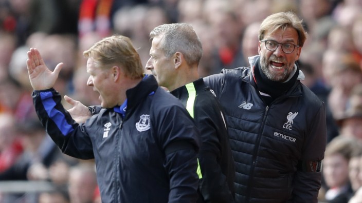 Liverpool manager Juergen Klopp and Everton manager Ronald Koeman clash as fourth official Martin Atkinson looks on