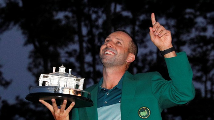 Sergio Garcia of Spain wears his green jacket and holds the Masters trophy after winning the 2017 Masters in Augusta