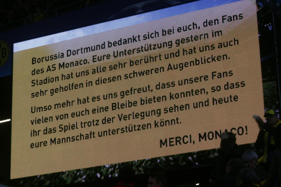 Borussia Dortmund display a message of thanks to Monaco fans before the match