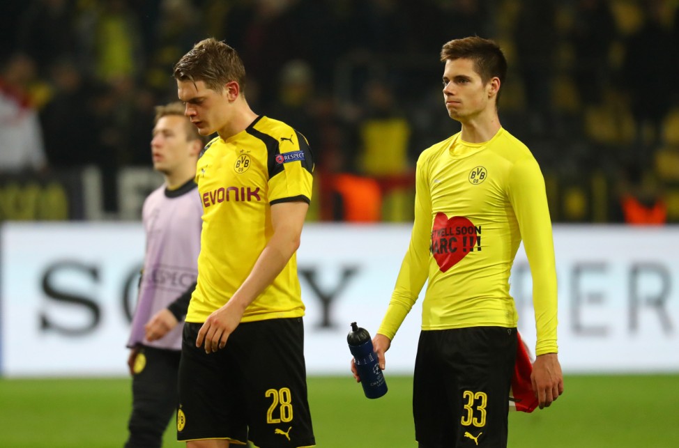 Borussia Dortmund's Julian Weigl wears a shirt in support of Marc Bartra as Matthias Ginter looks on at full time