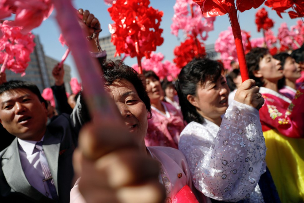 People cheer towards the stage where North Korean leader Kim Jong Un cut the ribbon during an opening ceremony of a newly constructed residential complex in Ryomyong street in Pyongyang