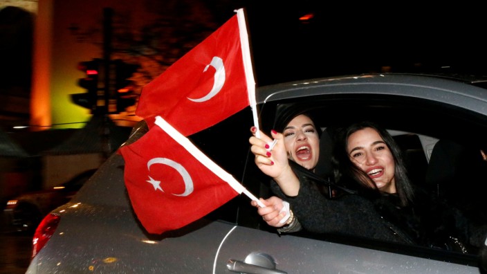 People of the Turkish community living in Germany, supporting Erdogan celebrate on Kurfuerstendamm boulevard after news bulletins on the outcome of Turkey's referendum on the constitution, in Berlin