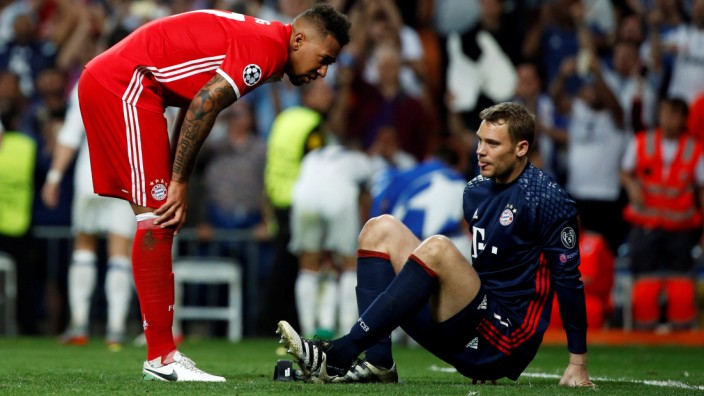 Bayern Munich's Jerome Boateng checks on Bayern Munich's goalkeeper Manuel Neuer after he injured his left foot during their UEFA Champions League quarterfinal second leg match against Real Madrid at Santiago Bernabeu stadium in Madrid