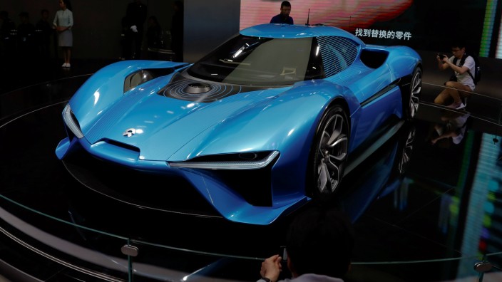 People gather around Nio EP9 electric car displayed at the auto show in Shanghai